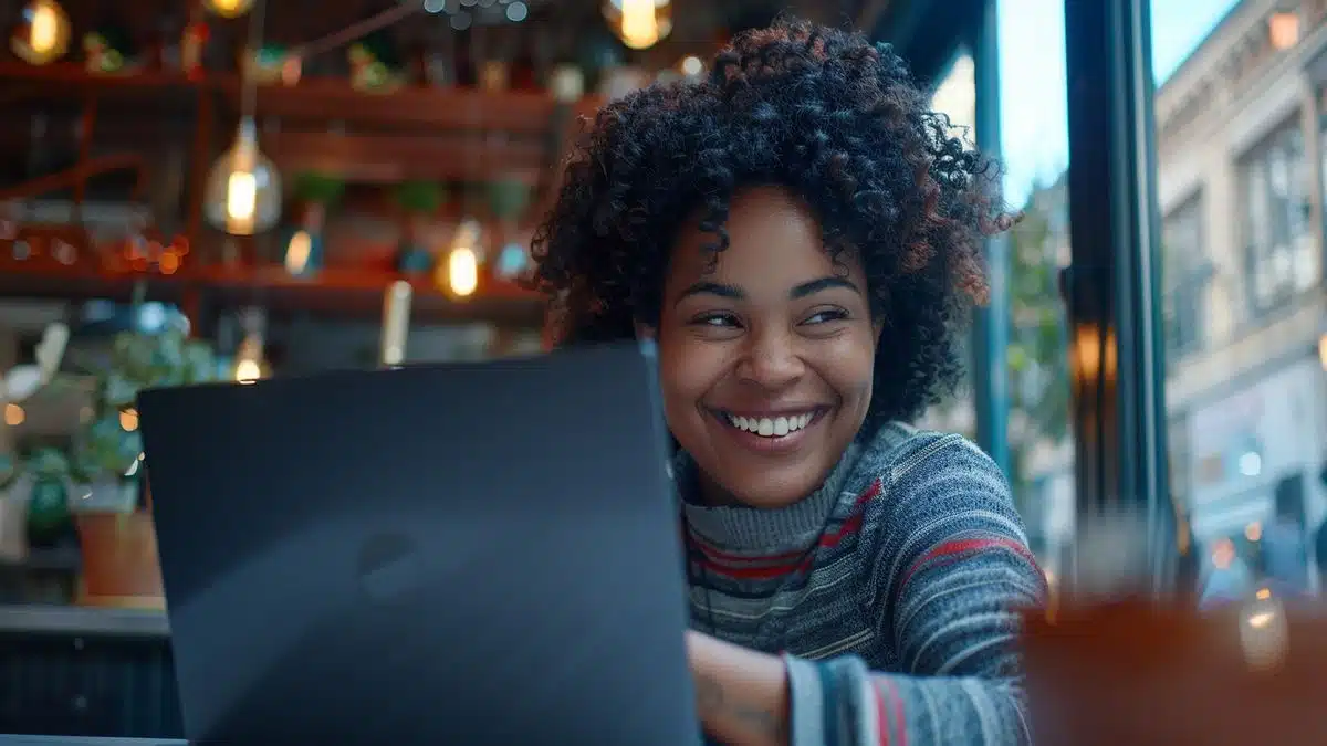 User smiling at a notification of successful Windows update on laptop.